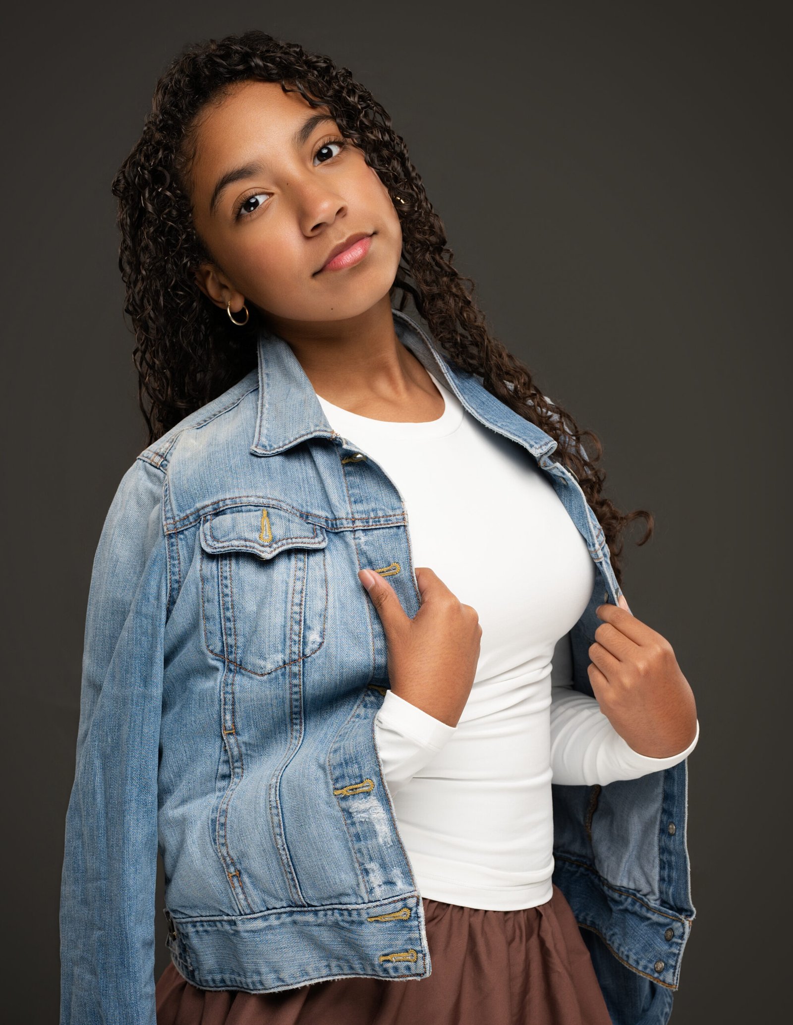 Teen model wearing a denim jacket in a professional portrait